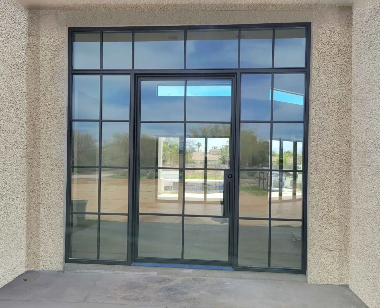 A large glass door with windows on the outside of it.